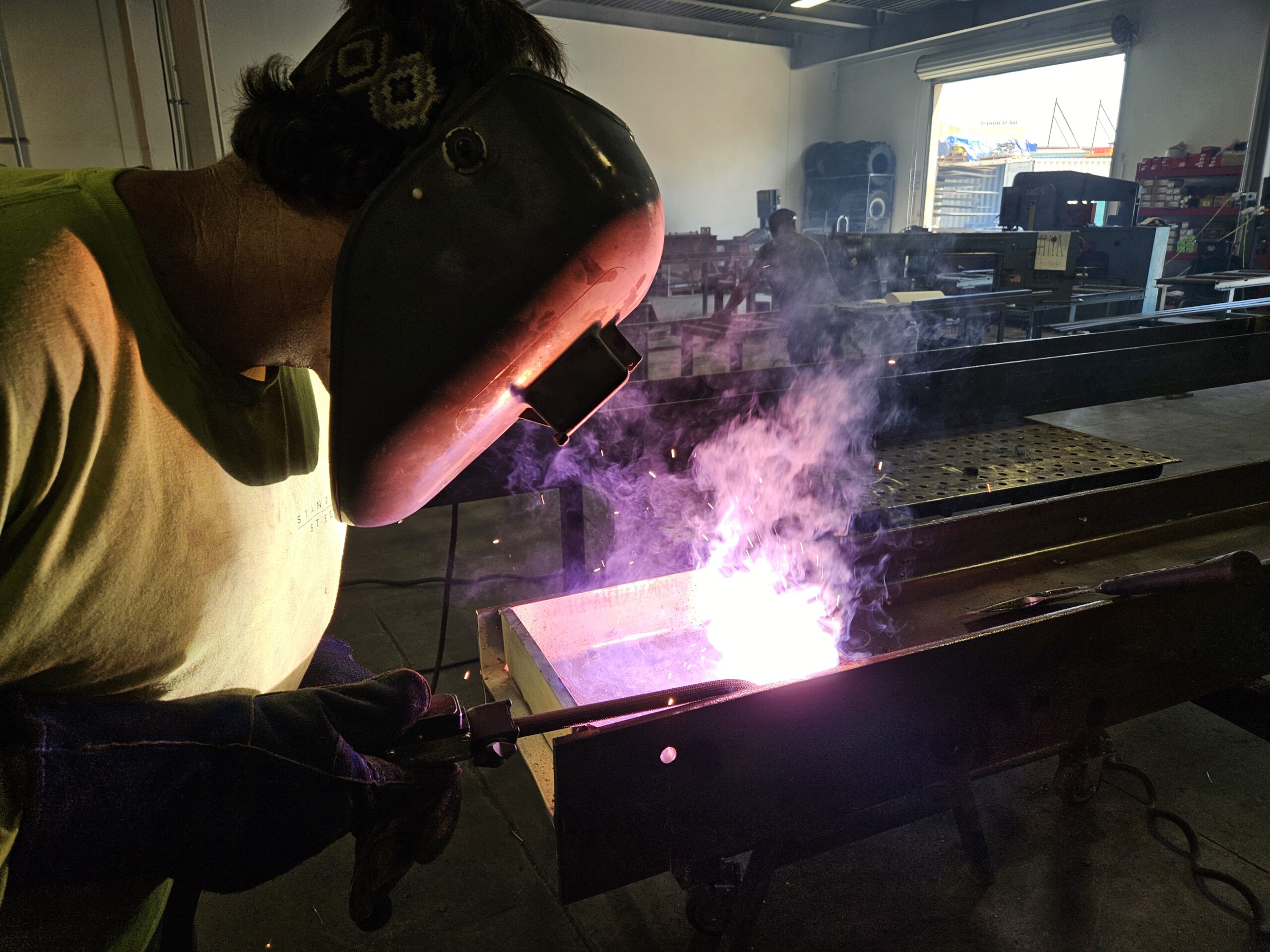 Welder_Actively_Welding_Inside_Metal_Shop